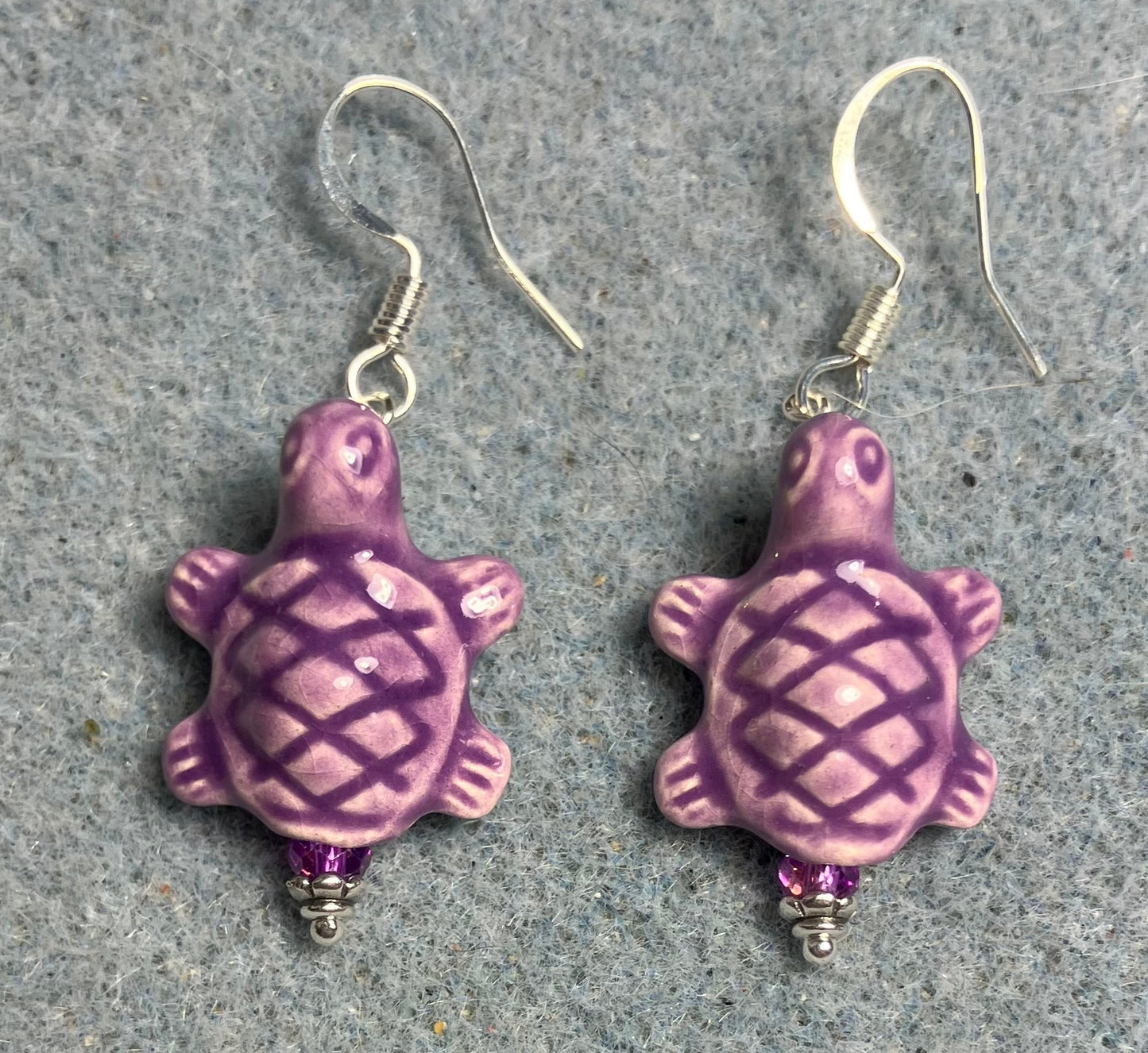 Purple ceramic turtle bead earrings adorned with purple Chinese crystal beads.