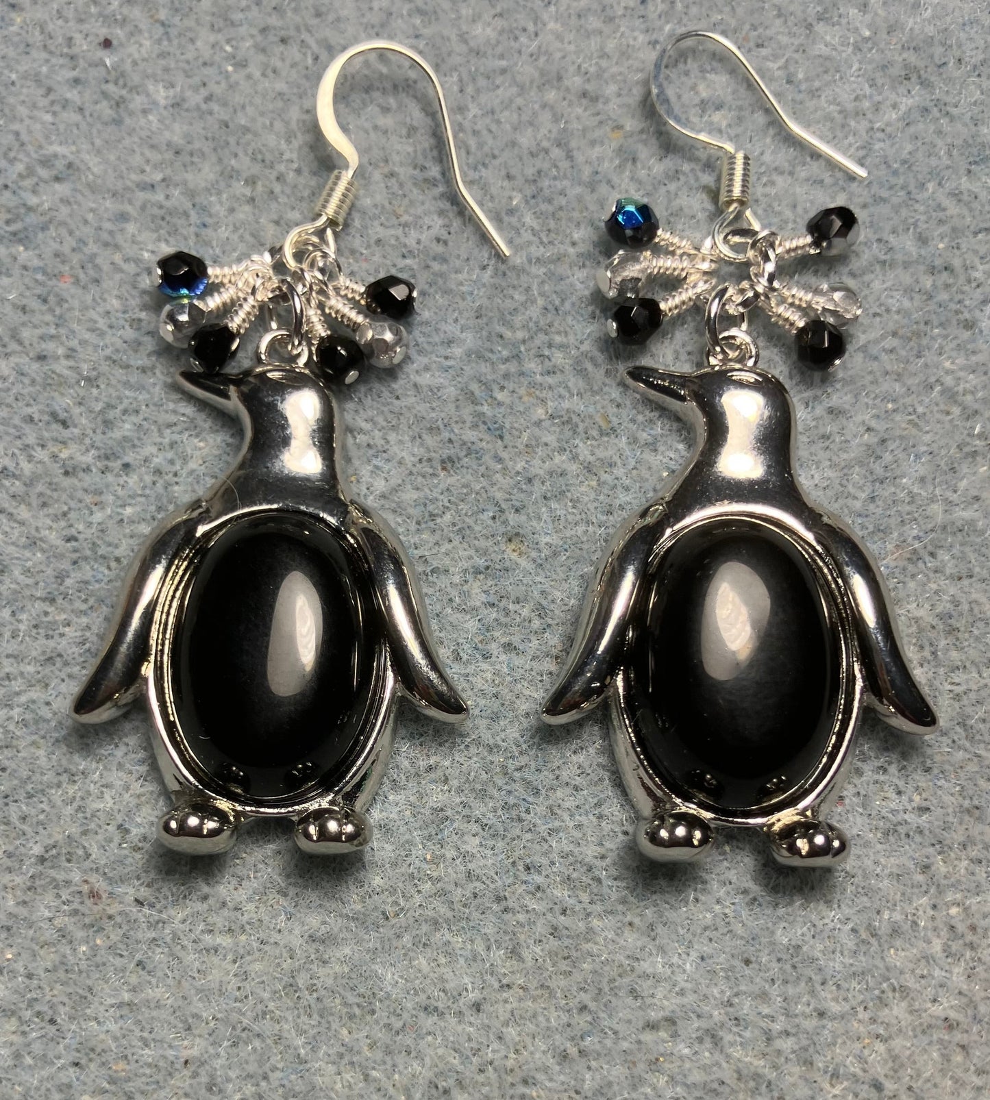 Large silver and black onyx gemstone penguin charm earrings adorned with small dangling black and silver Czech glass beads.