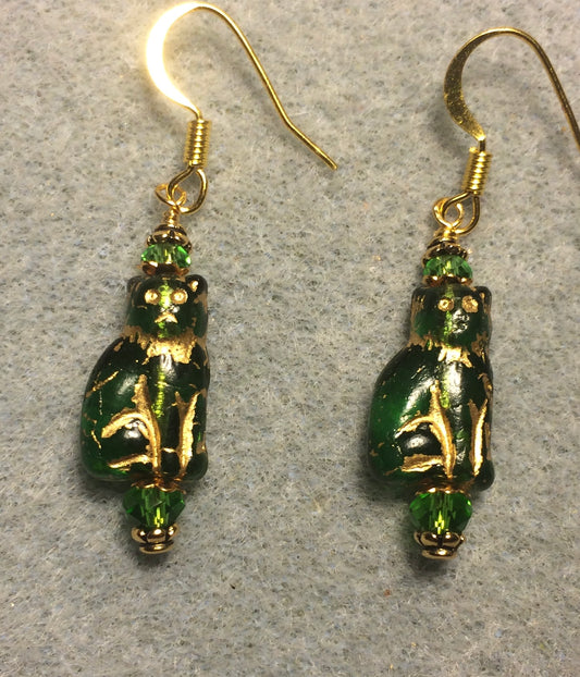 Small translucent emerald green and gold Czech glass cat bead earrings adorned with emerald green Chinese crystal beads.