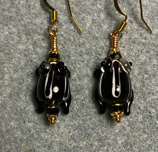 Very small black with white stripes lamp work frog bead earrings adorned with black Chinese crystal beads.
