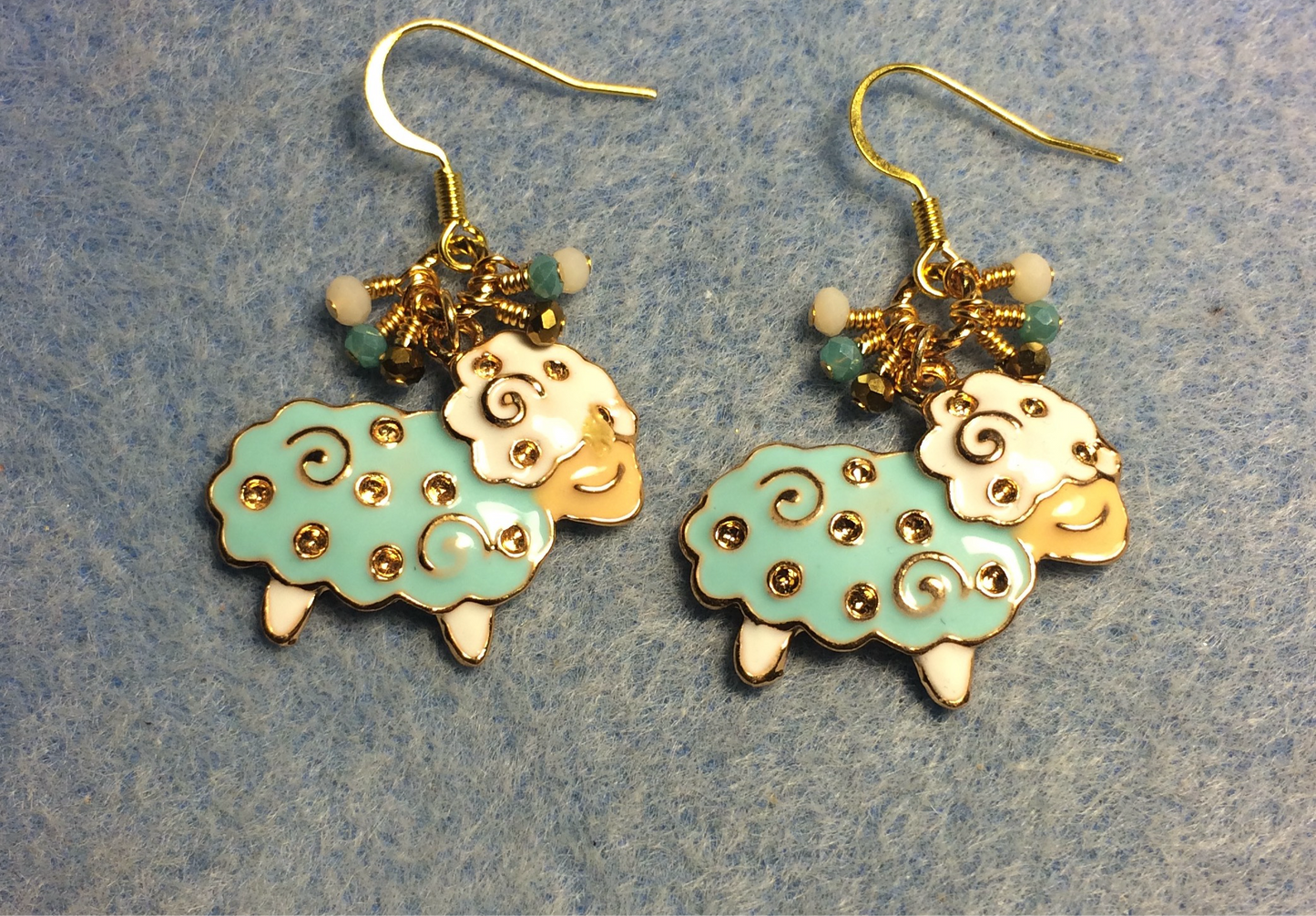 Aqua, gold, and white enamel sheep charm earrings adorned with tiny dangling aqua, gold and white Chinese crystal beads.