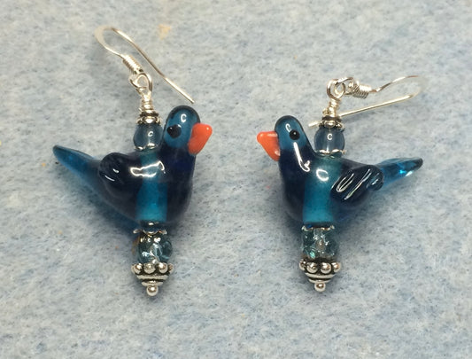 Translucent Montana blue lamp work songbird bead earrings adorned with Montana blue Czech glass beads.