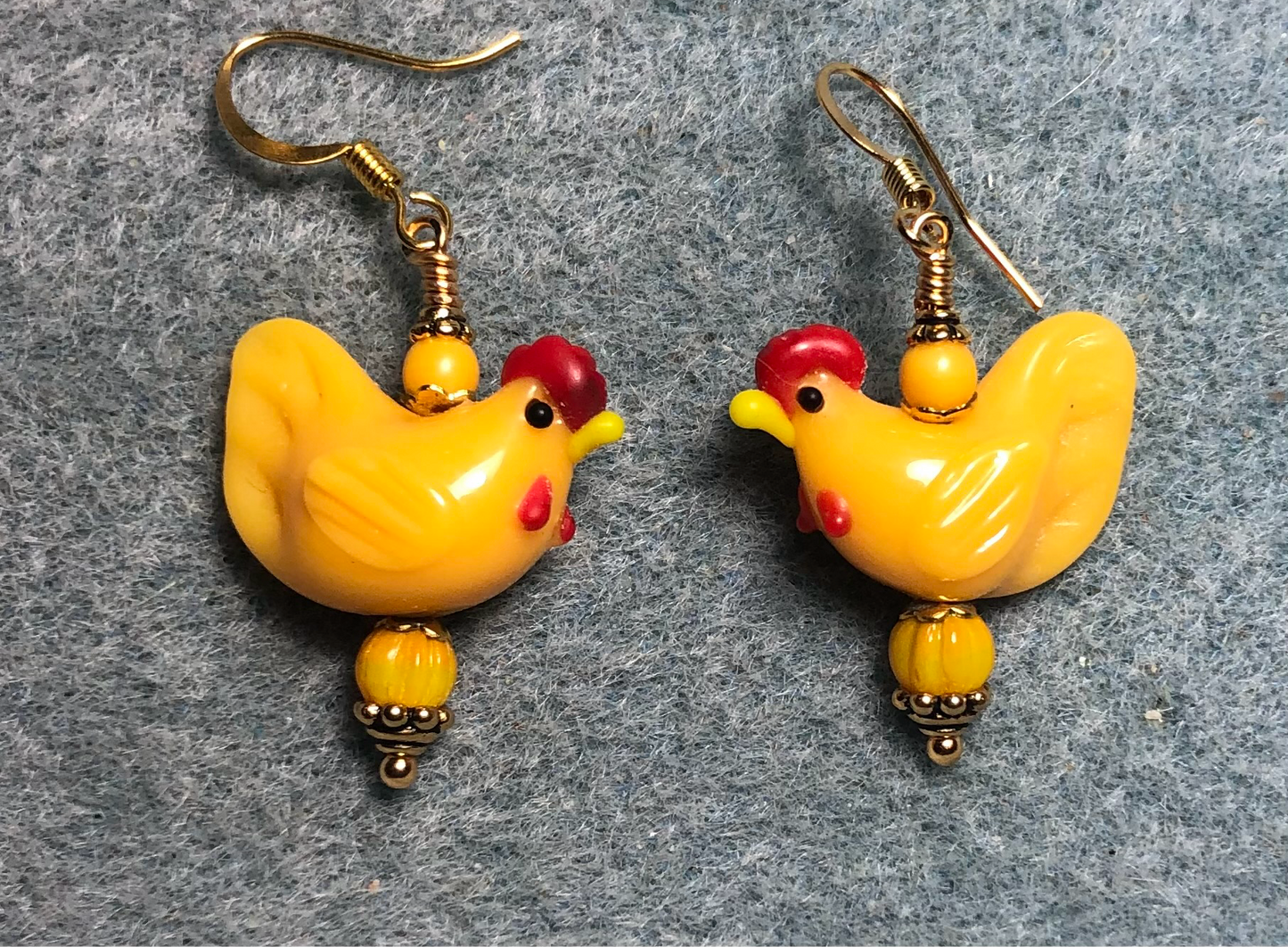 Golden yellow lamp work chicken bead earrings adorned with golden yellow Czech glass beads.