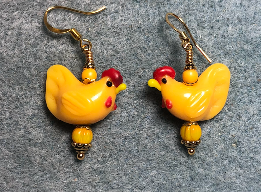 Golden yellow lamp work chicken bead earrings adorned with golden yellow Czech glass beads.