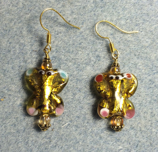 Gold and pink lamp work butterfly bead earrings adorned with topaz Czech glass beads.