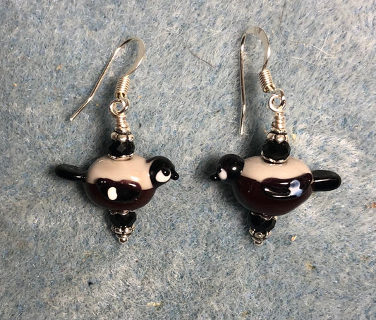 Small black and tan lamp work bullfinch bird bead earrings adorned with black Chinese crystal beads.