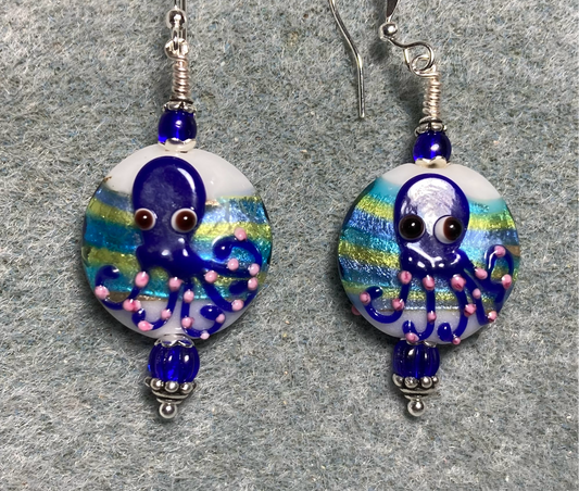Dark blue, green, and pink lamp work octopus bead earrings adorned with dark blue Czech glass beads.