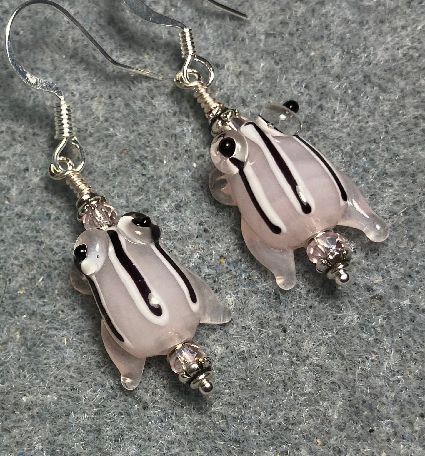Very small translucent pink with black stripes lamp work frog bead earrings adorned with light pink Chinese crystal beads.