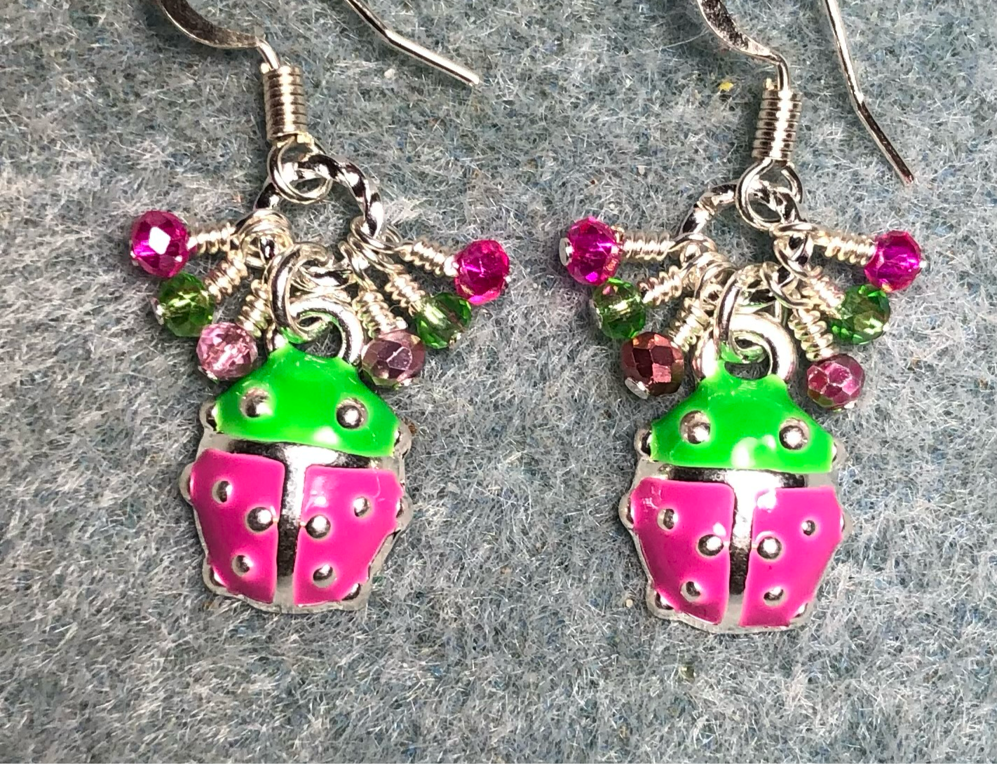 Tiny pink, green, and silver enamel ladybug charm earrings adorned with tiny dangling pink and green Chinese crystal beads.