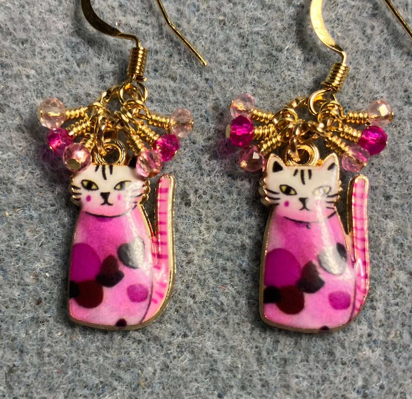 Hot pink and light pink enamel cat charm earrings adorned with tiny dangling hot pink and light pink Chinese crystal beads.