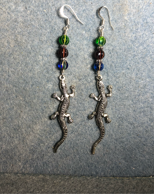 Long silver lizard charm earrings adorned with blue, dark red, and green Czech glass melon beads