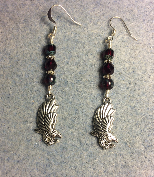 Silver flying eagle charm earrings adorned with ruby red Czech glass beads