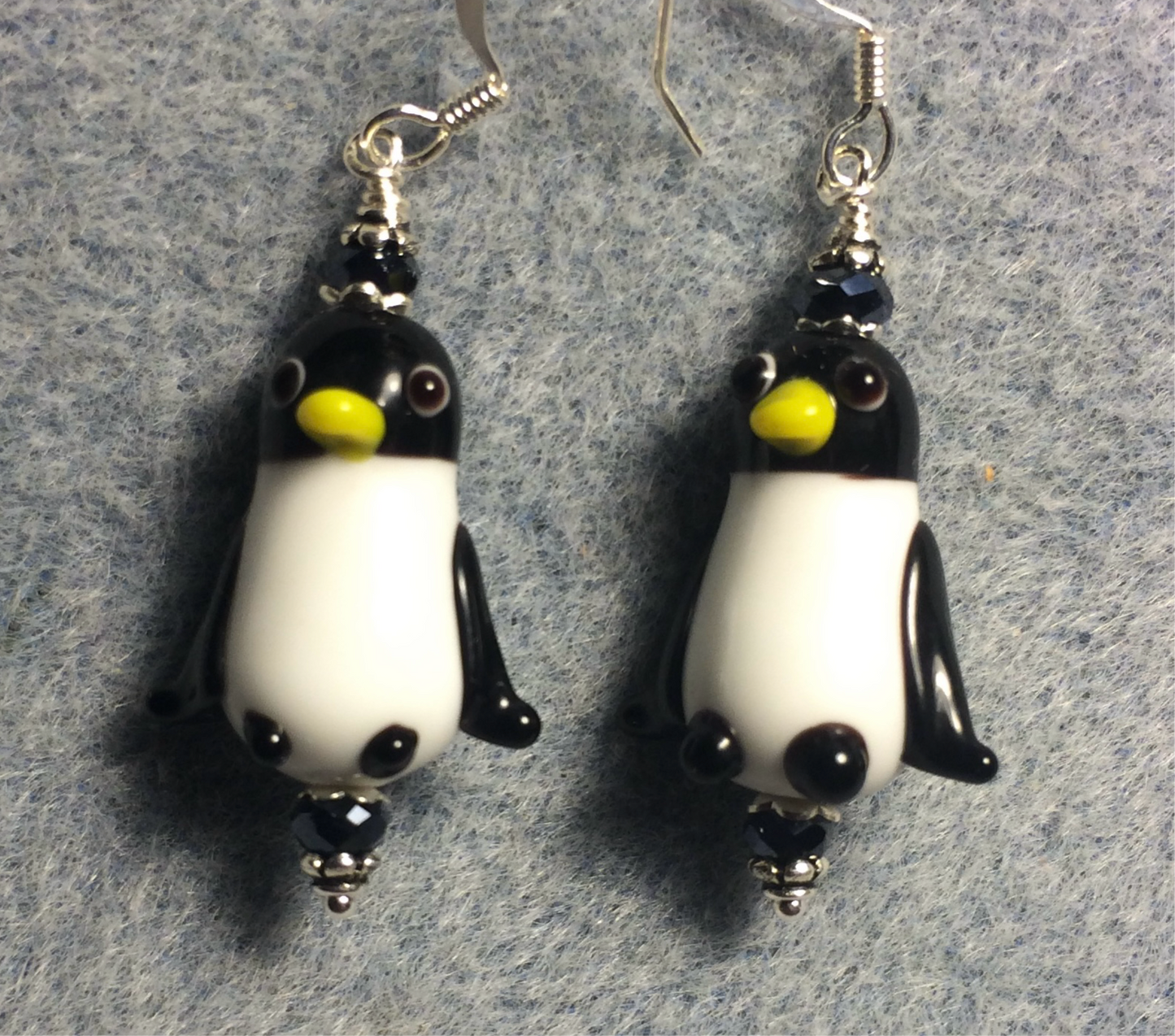 Black and white lamp work penguin bead earrings adorned with black Chinese crystal  beads.