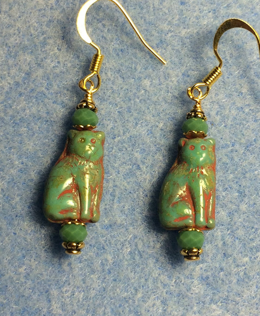 Small opaque green Czech glass cat bead earrings adorned with green Chinese crystal beads.