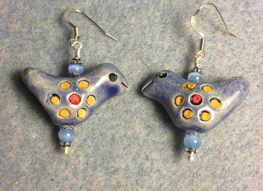 Medium blue, yellow, and red ceramic songbird bead earrings adorned with blue Czech glass beads.