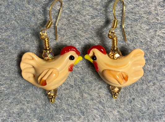 Light tan lamp work chicken bead earrings adorned with amber Chinese crystal beads.