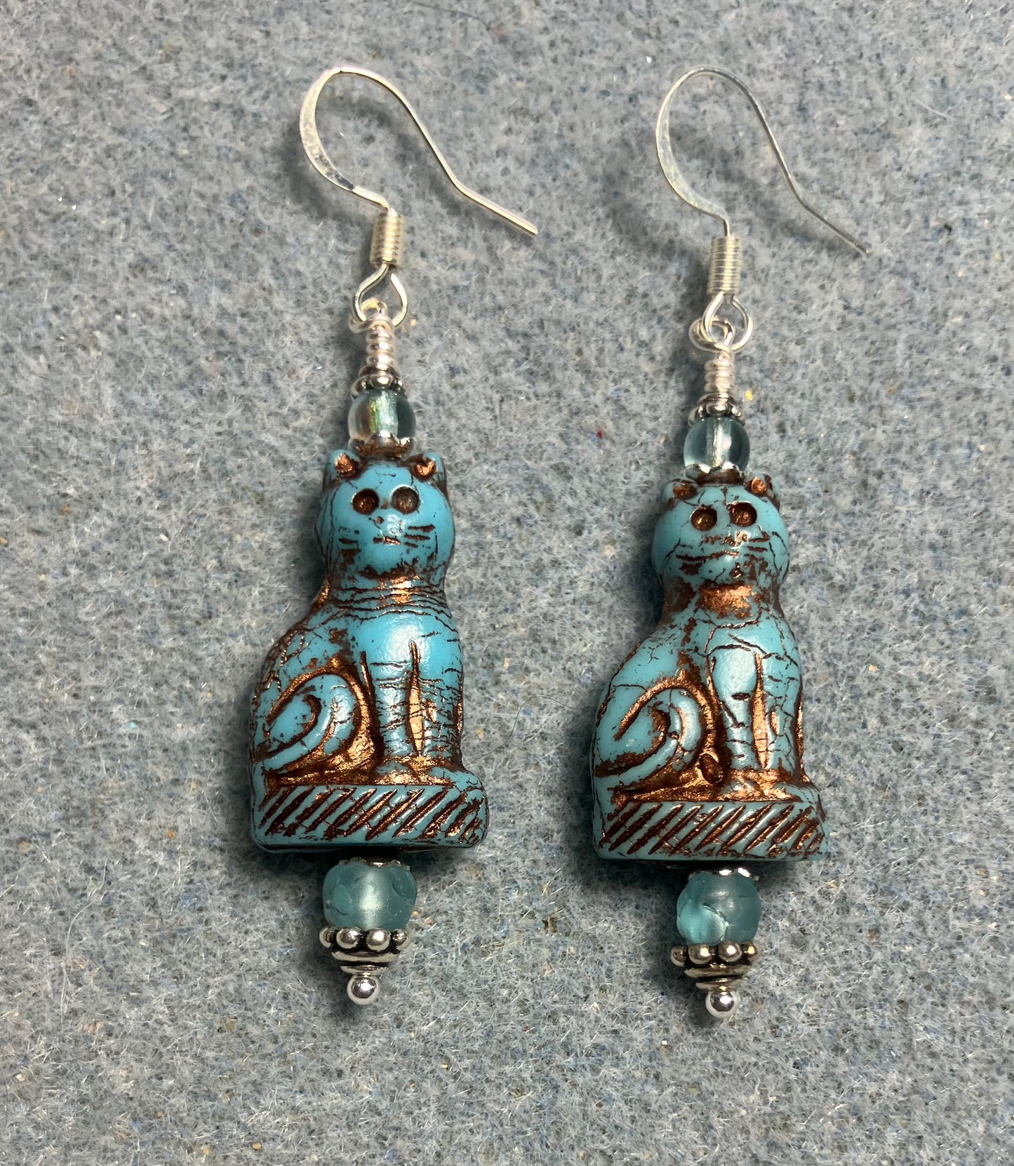Opaque turquoise (with copper inlay) fancy Czech glass cat bead earrings adorned with light turquoise Czech glass beads.