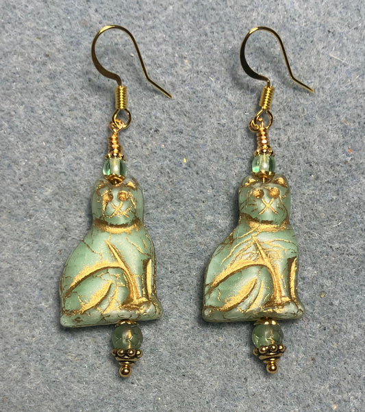 Light green (with gold inlay) Czech glass cat bead earrings adorned with light green Czech glass beads.