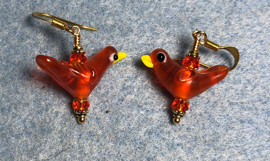Translucent orange lamp work songbird bead earrings adorned with orange Chinese crystal beads.