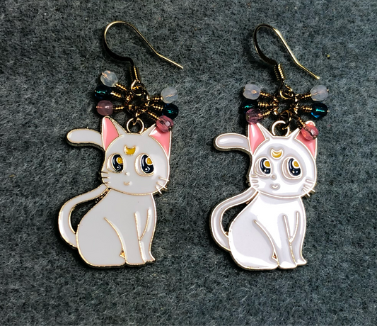 White and pink enamel cat charm earrings adorned with tiny dangling white, pink, and turquoise Czech glass beads.