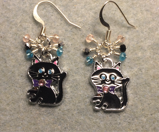 Black, turquoise, and pink enamel cat charm earrings adorned with tiny dangling black, turquoise, and pink beads.