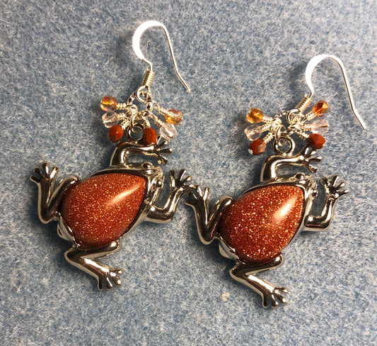 Large silver and orange goldstone gemstone frog charm earrings adorned with small dangling orange and clear Czech glass beads.