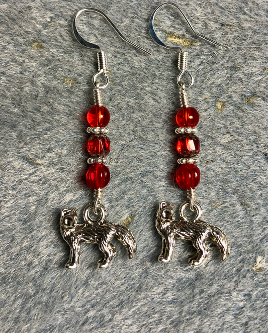 Silver fox charm earrings adorned with small red Czech glass beads.