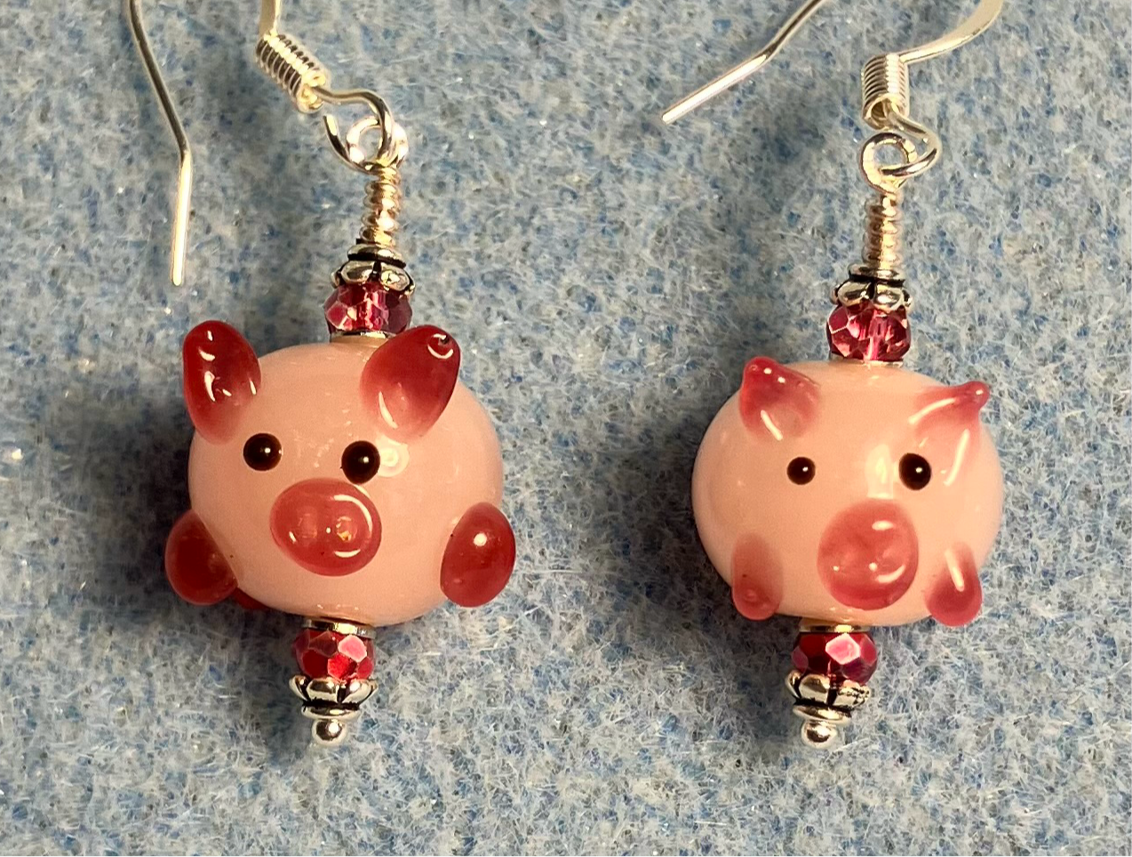 Light pink and hot pink lamp work pig bead earrings adorned with hot pink Chinese crystal beads.