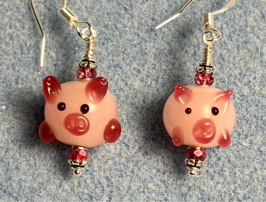 Light pink and hot pink lamp work pig bead earrings adorned with hot pink Chinese crystal beads.
