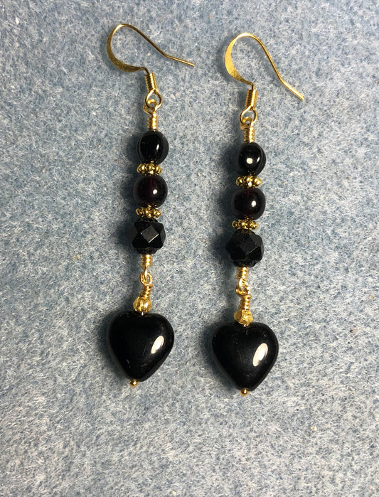 Small black Czech glass heart bead earrings adorned with black Czech glass beads.