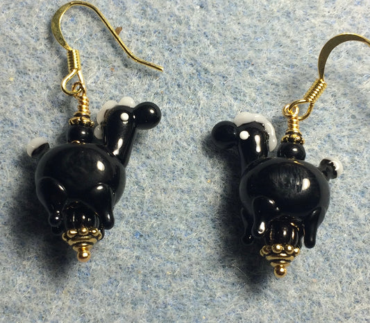 Opaque black lamp work horse bead earrings adorned with black Czech glass beads.