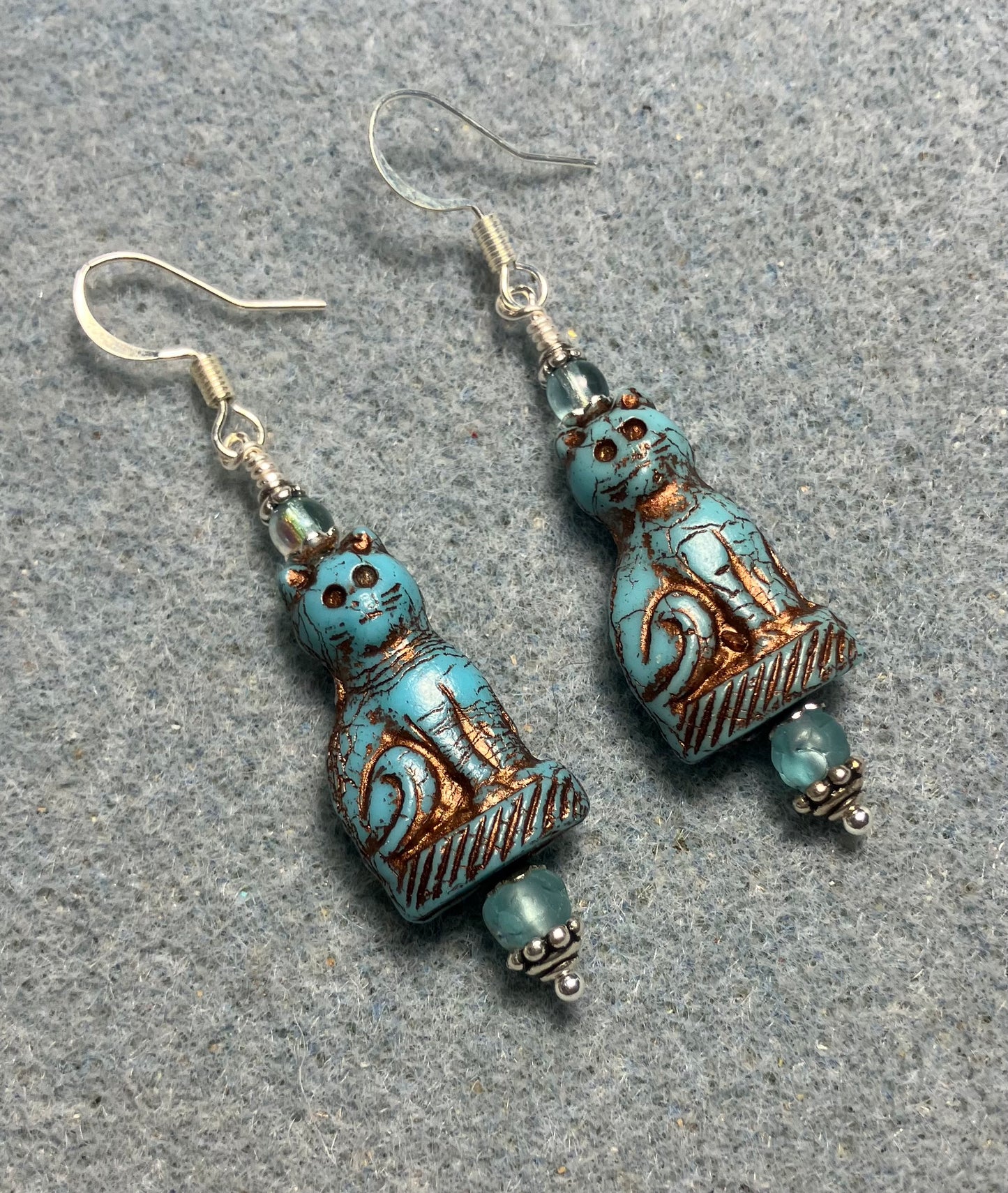 Opaque turquoise (with copper inlay) fancy Czech glass cat bead earrings adorned with light turquoise Czech glass beads.