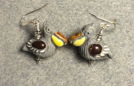 Gray, yellow, and brown ceramic pelican bead earrings adorned with gray Chinese crystal beads.