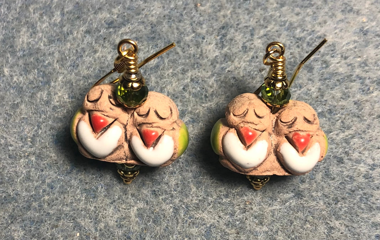 Small tan, red, and olive green ceramic pair of lovebird bead earrings adorned with olive green Chinese crystal beads.