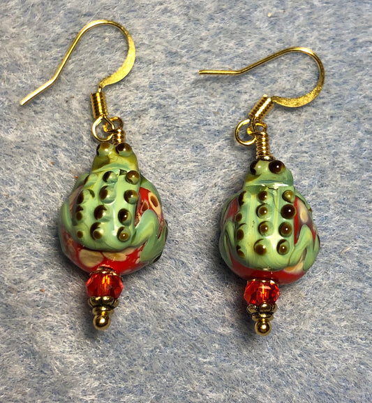Small red and green lamp work frog bead earrings adorned with orange red Chinese crystal beads.