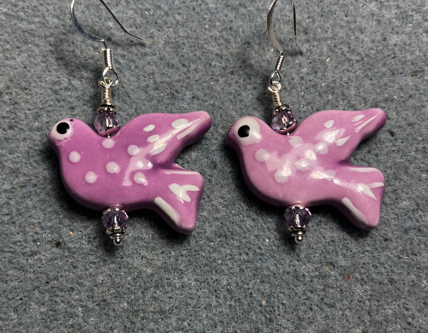 Large lavender ceramic flying dove bead earrings adorned with lavender Chinese crystal beads.