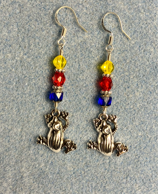 Silver frog charm earrings adorned with dark blue, red, yellow Czech glass beads.