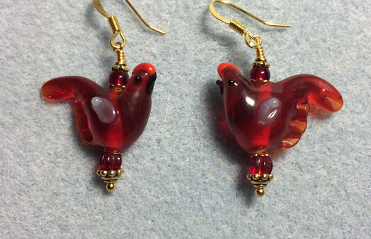 Translucent dark red lamp work songbird bead earrings adorned with dark red Czech glass beads.