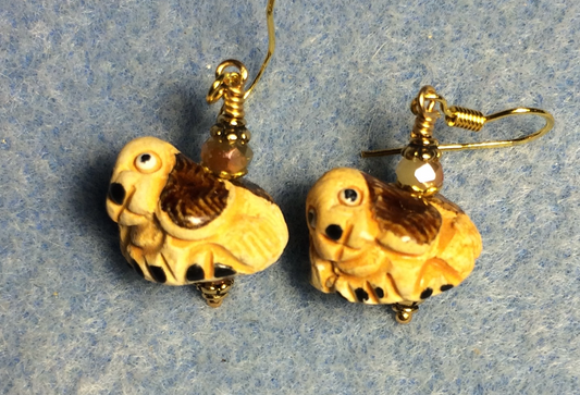 Small tan and brown ceramic hound dog bead earrings adorned with tan Chinese crystal beads.