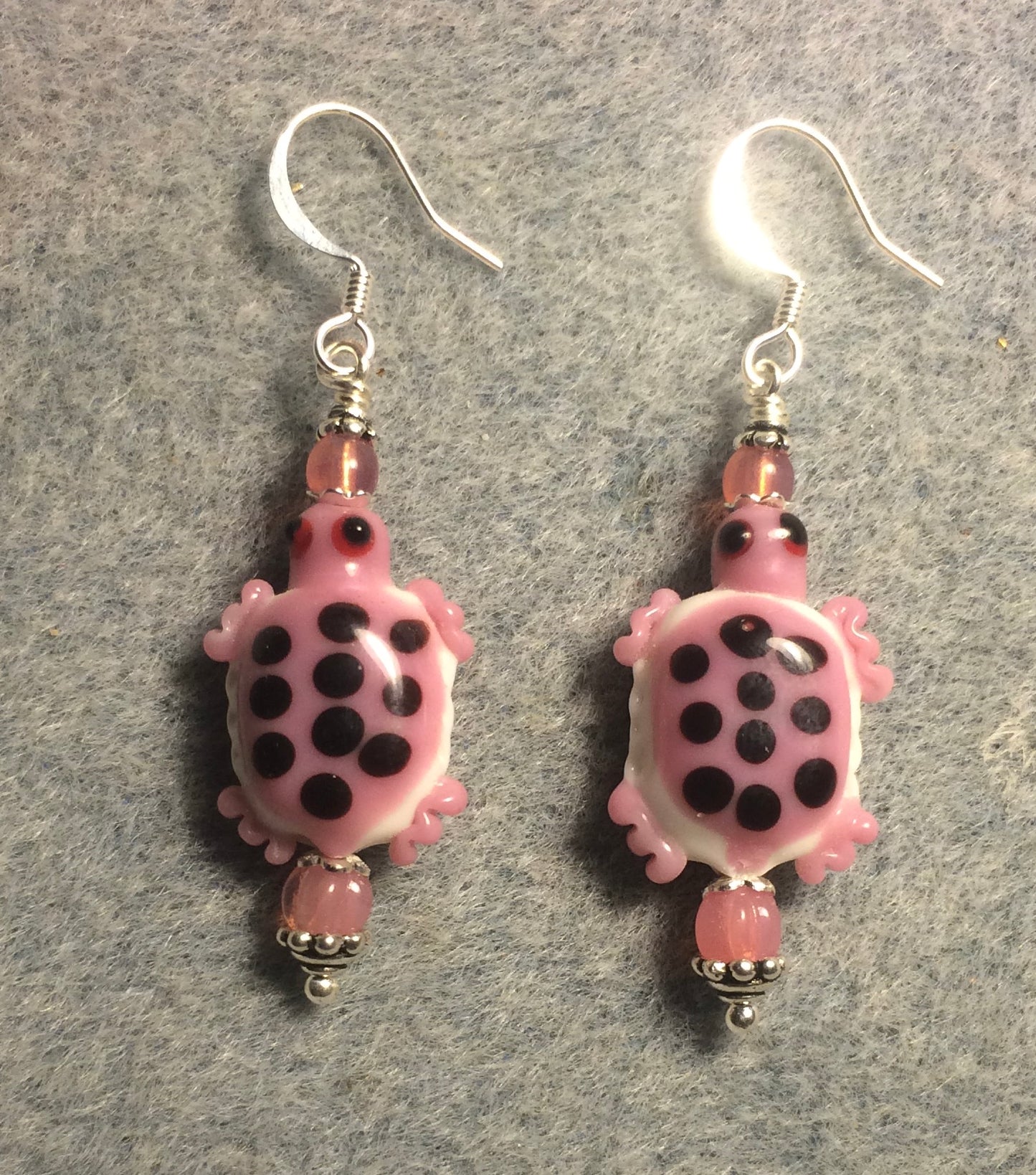 Pink and white lamp work spotted turtle bead earrings adorned with pink Czech glass beads.