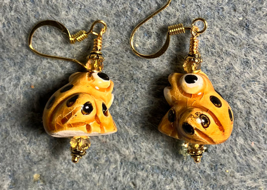 Small amber and black ceramic spotted frog bead earrings adorned with amber Chinese crystal beads.