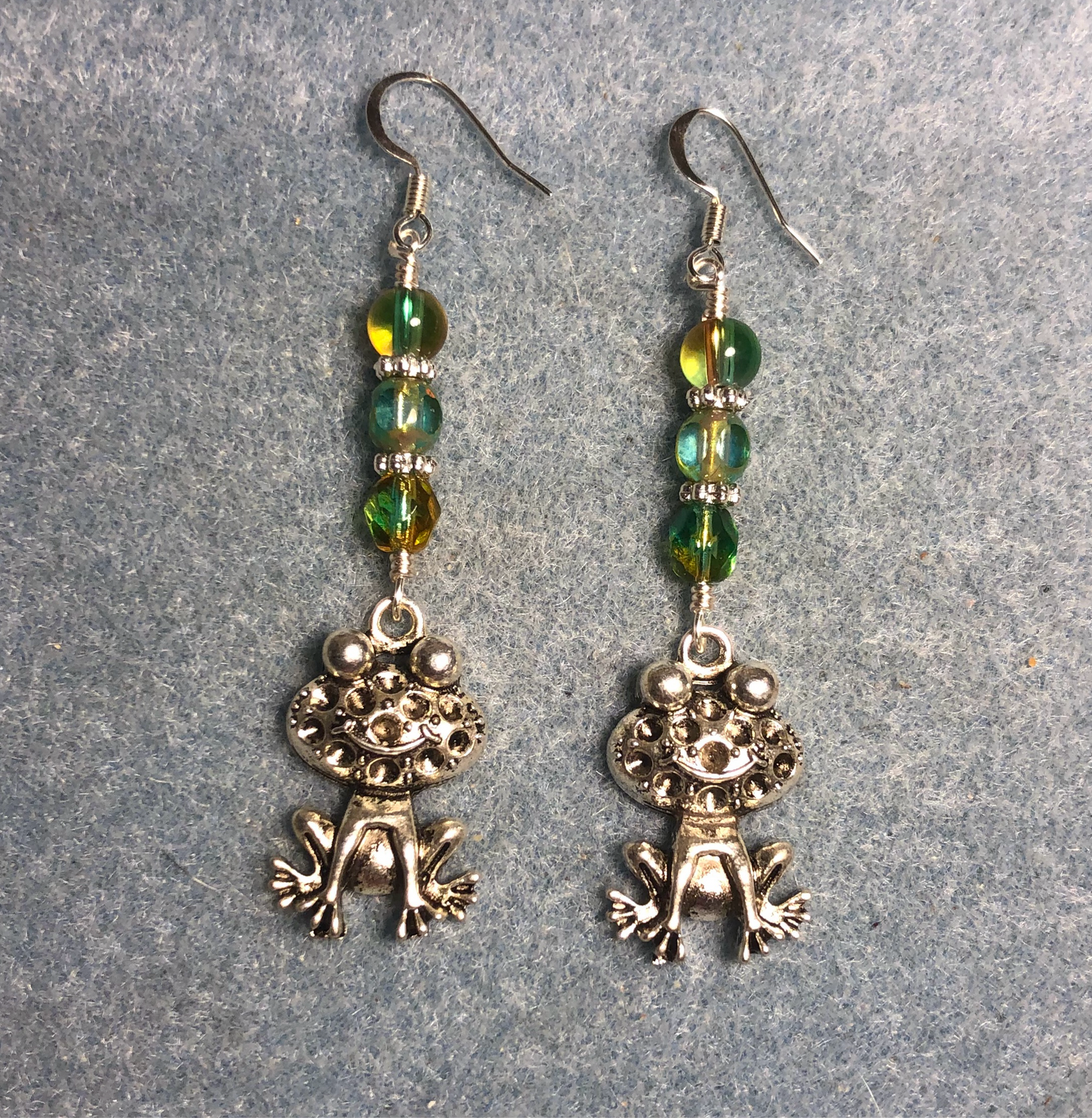 Silver silly frog charm earrings adorned with blue green Czech glass beads