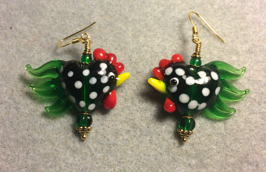 Emerald green with white spots heart shaped lamp work rooster bead earrings adorned with emerald green Czech glass beads.
