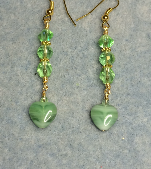 Small light green Czech glass heart bead earrings adorned with light green Czech glass beads.