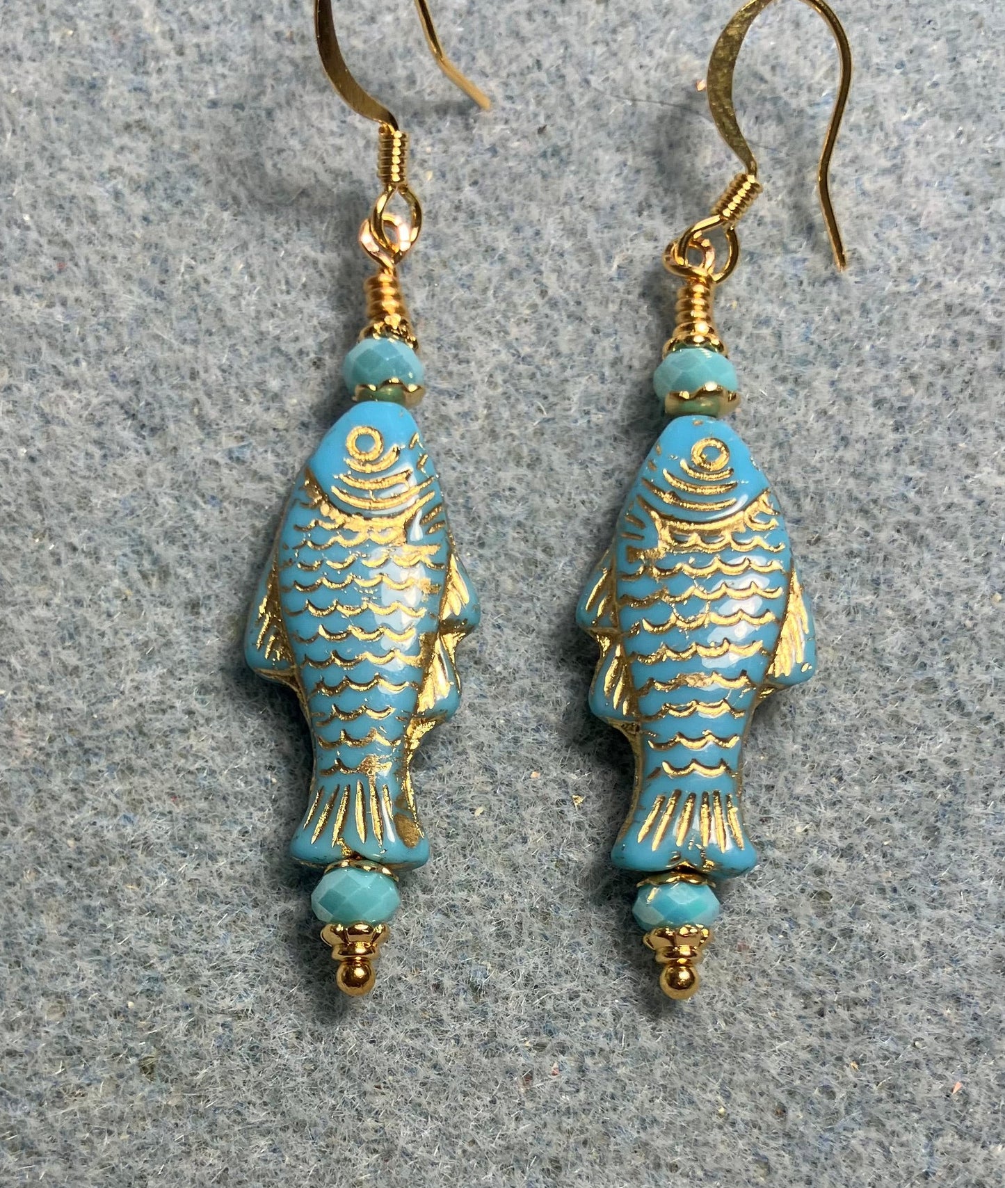 Light turquoise (with gold inlay) Czech glass fish bead earrings adorned with turquoise Chinese crystal beads.