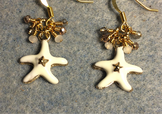 White and gold enamel starfish charm earrings adorned with tiny dangling white, gold, and clear Chinese crystal beads.