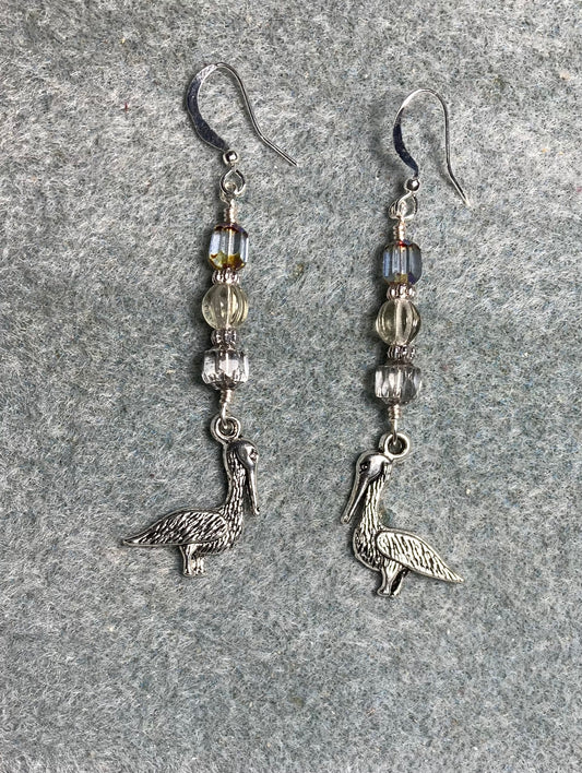 Silver pelican charm earrings adorned with gray Czech glass beads