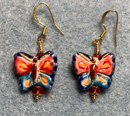 Red and blue ceramic butterfly bead earrings adorned with red Chinese crystal beads.