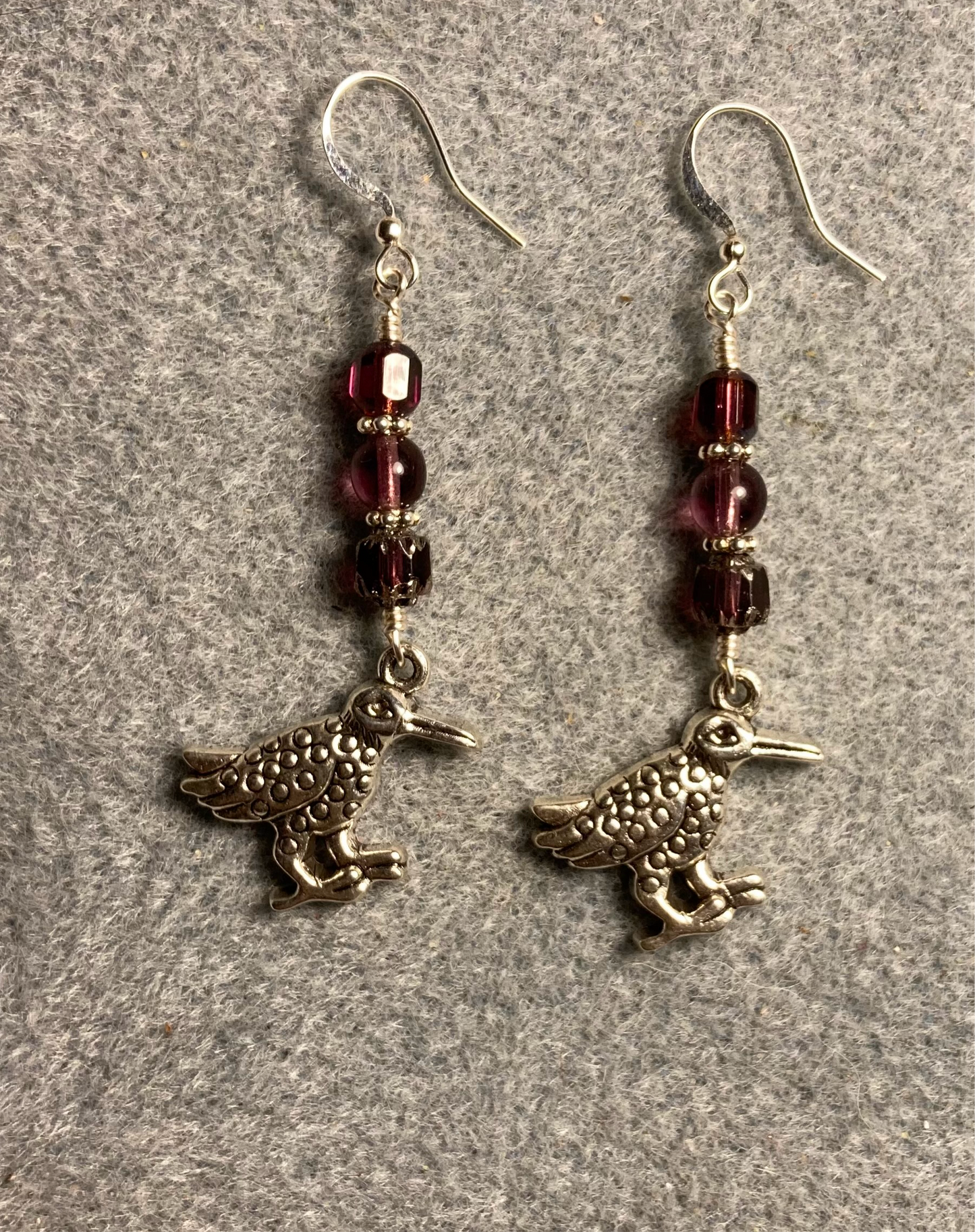 Silver kiwi charm earrings adorned with purple Czech glass beads