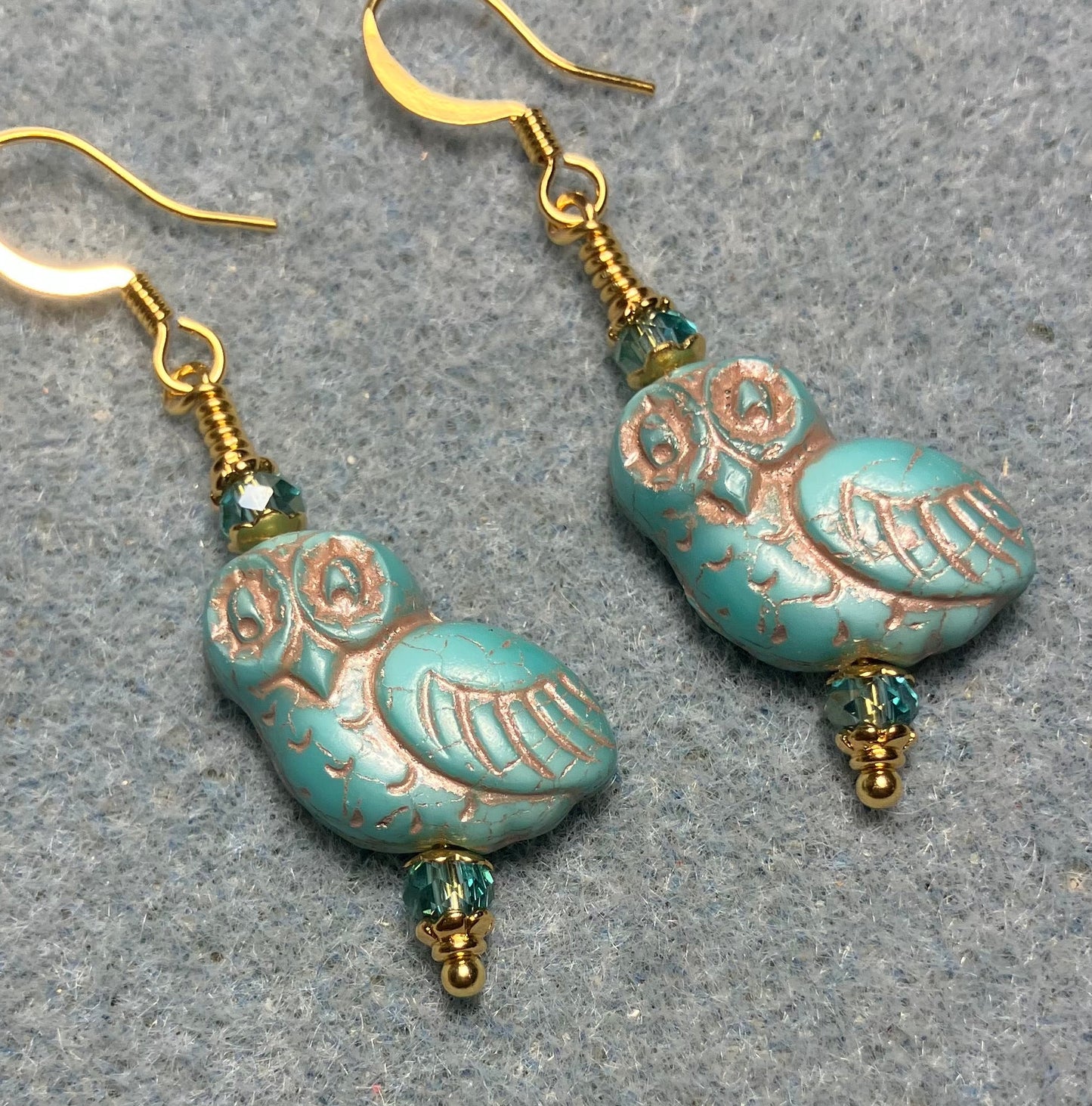Turquoise (with copper inlay) fancy Czech glass owl bead earrings adorned with turquoise Chinese crystal beads.